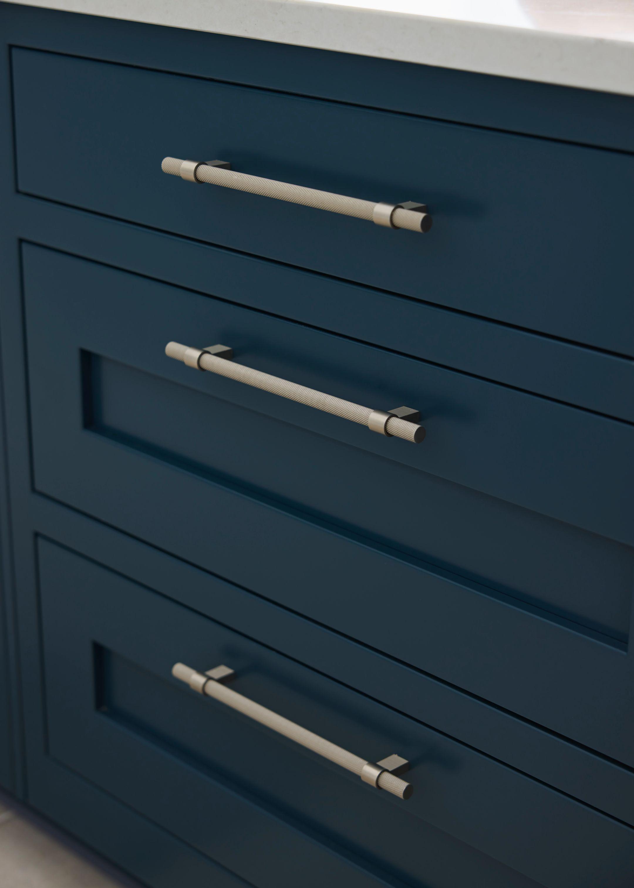 Knurled bar handle detail on blue in-frame drawers