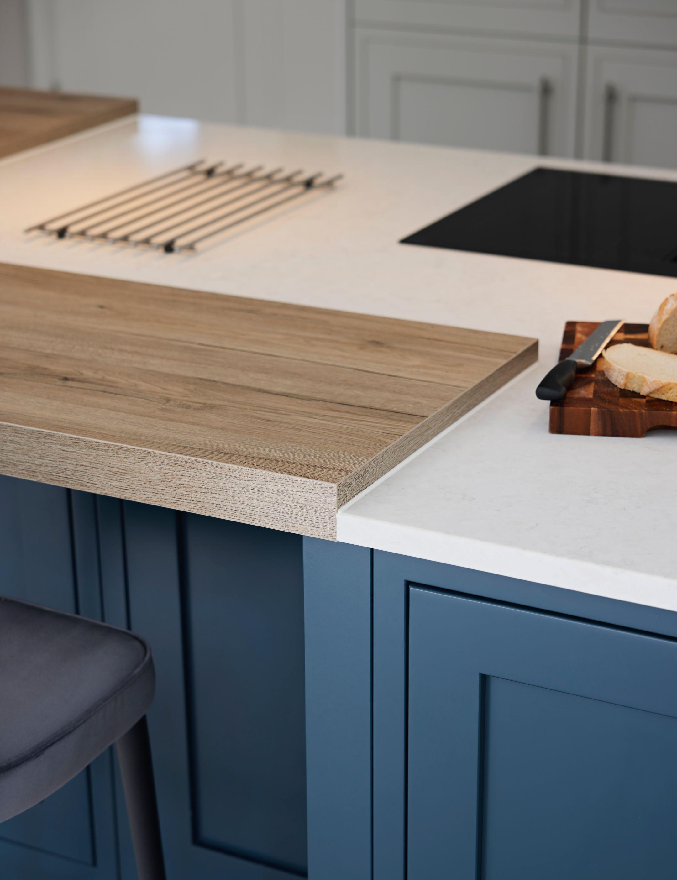 Close up of where quartz worktop meets breakfast bar and island pilaster