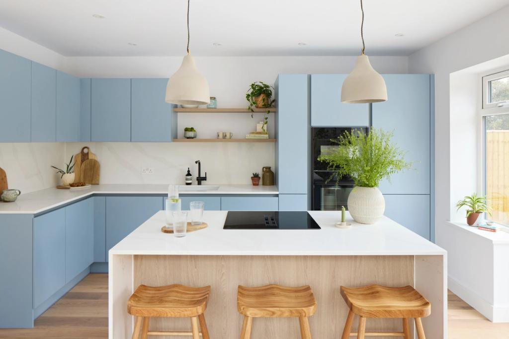 Light blue handleless kitchen with wood accents